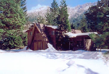 The A-frame family lodge under snow in winter